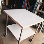 Square dual level table on wheels with locks.